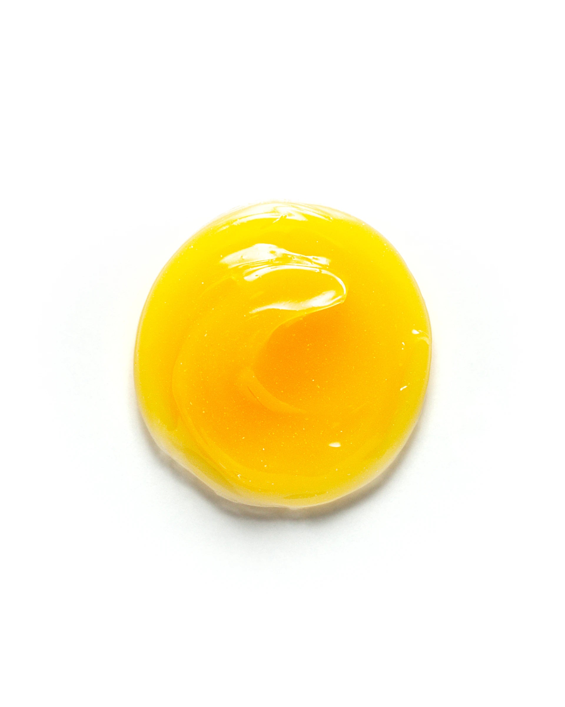 Vibrant yellow dollop of Cactus Flower & Poppy Overnight Eye Mask on a white background. The glossy, gel-like texture reflects its deeply hydrating and restorative formula. Skincare product designed to nourish and brighten the delicate under-eye area while you sleep.