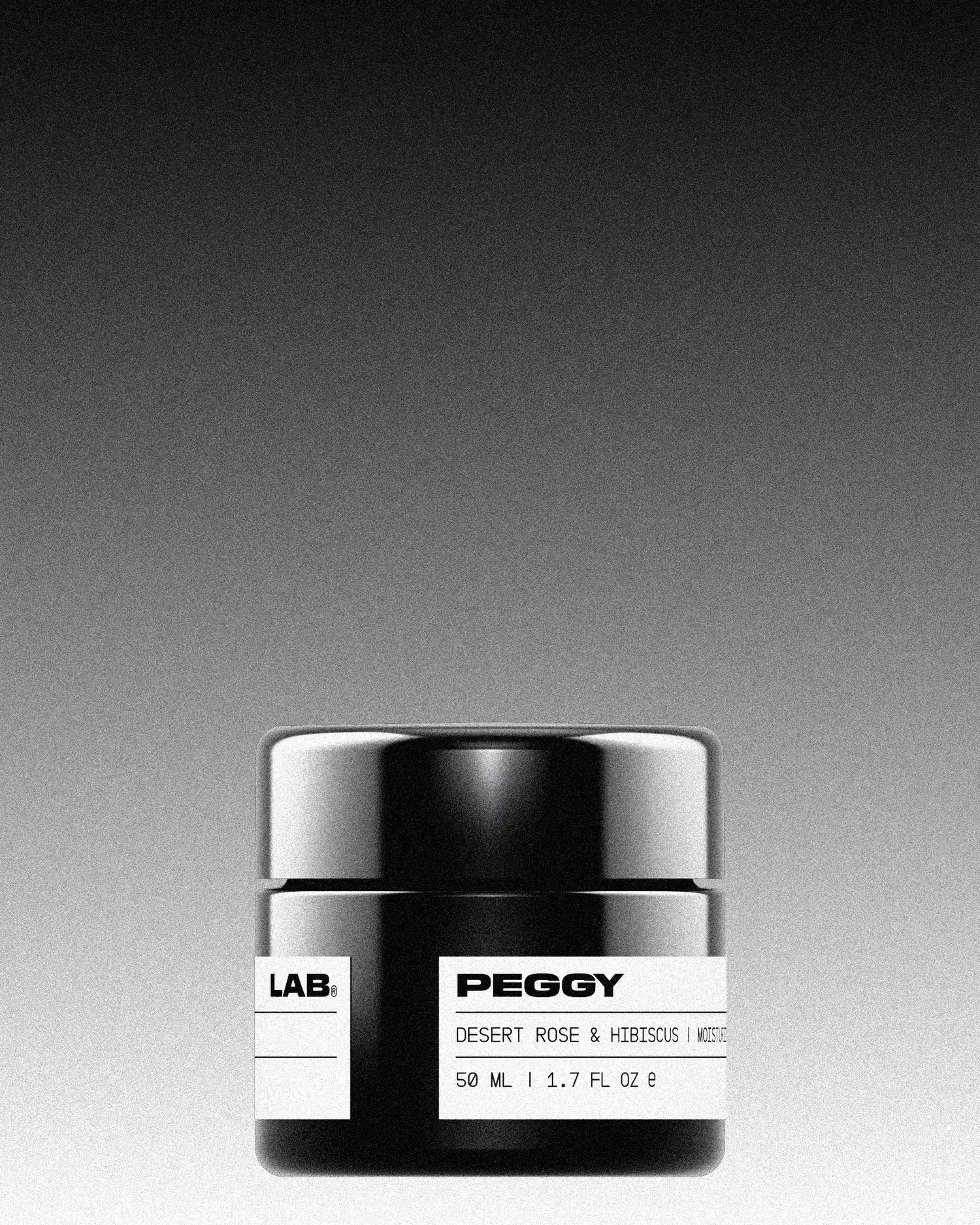 Black jar with white label. The label reads ‘PEGGY LAB®, Desert Rose & Hibiscus | Moisturizing Face Cream, 50 ml | 1.7 fl oz’. The background is a vertical gradient starting with solid black at the top, ending with solid white at the bottom.