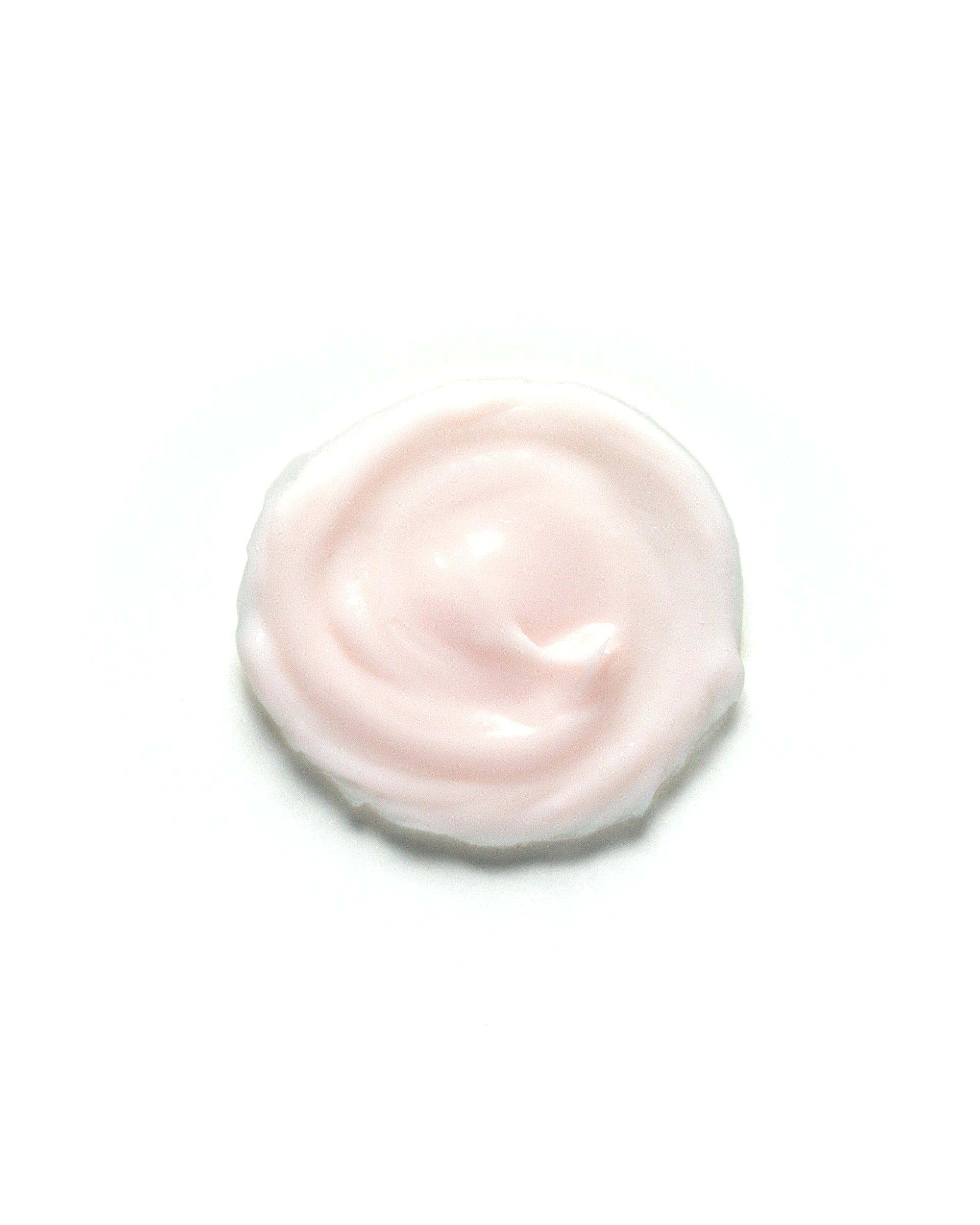 Soft pink swirl of Desert Rose & Hibiscus Moisturizing Face Cream on a white background. The rich, creamy texture highlights its nourishing and hydrating properties. Skincare product formulated to soothe, and moisturize dry or sensitive skin.